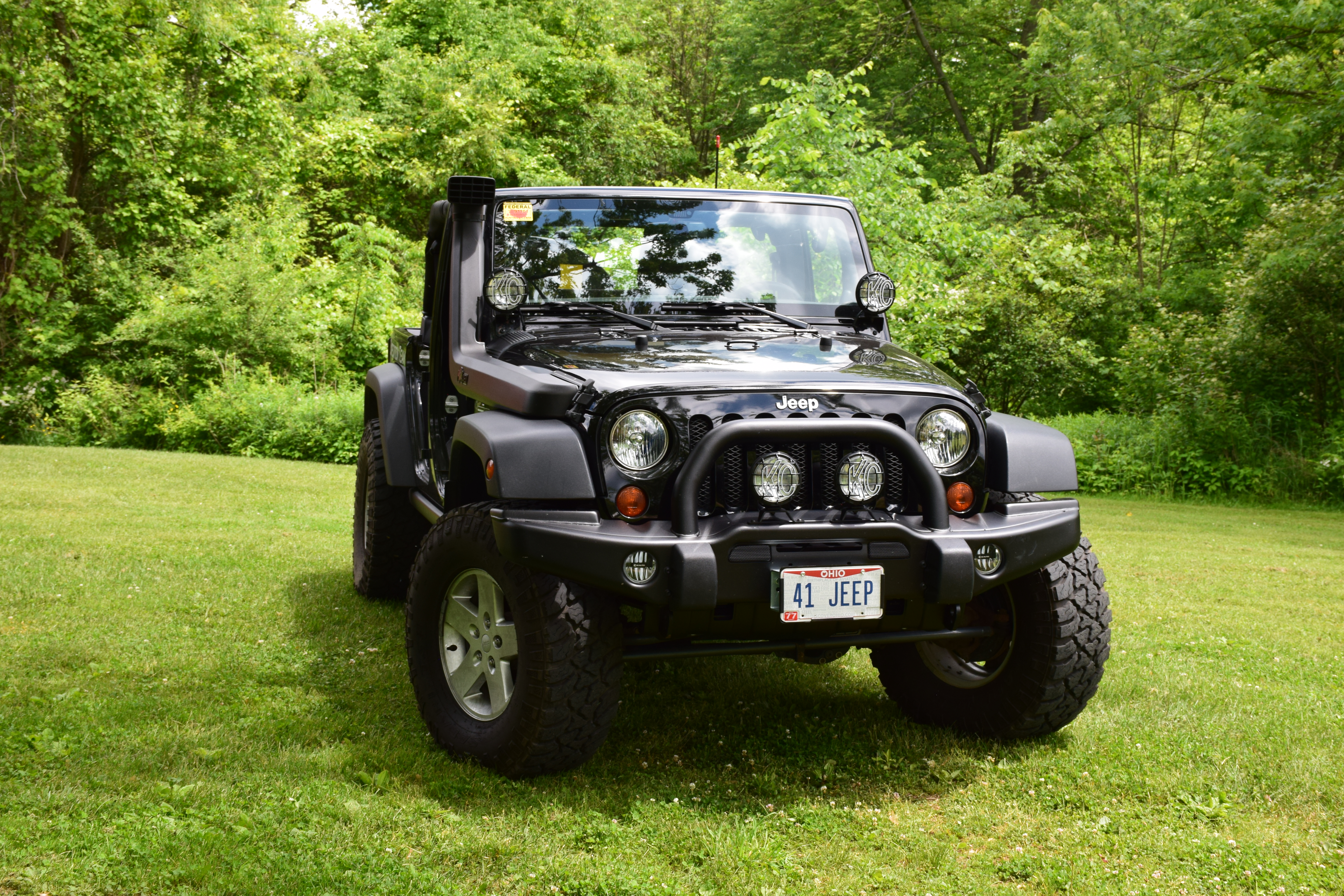Front three-quarter view of the black 2013 Jeep Wrangler Unlimited Sport