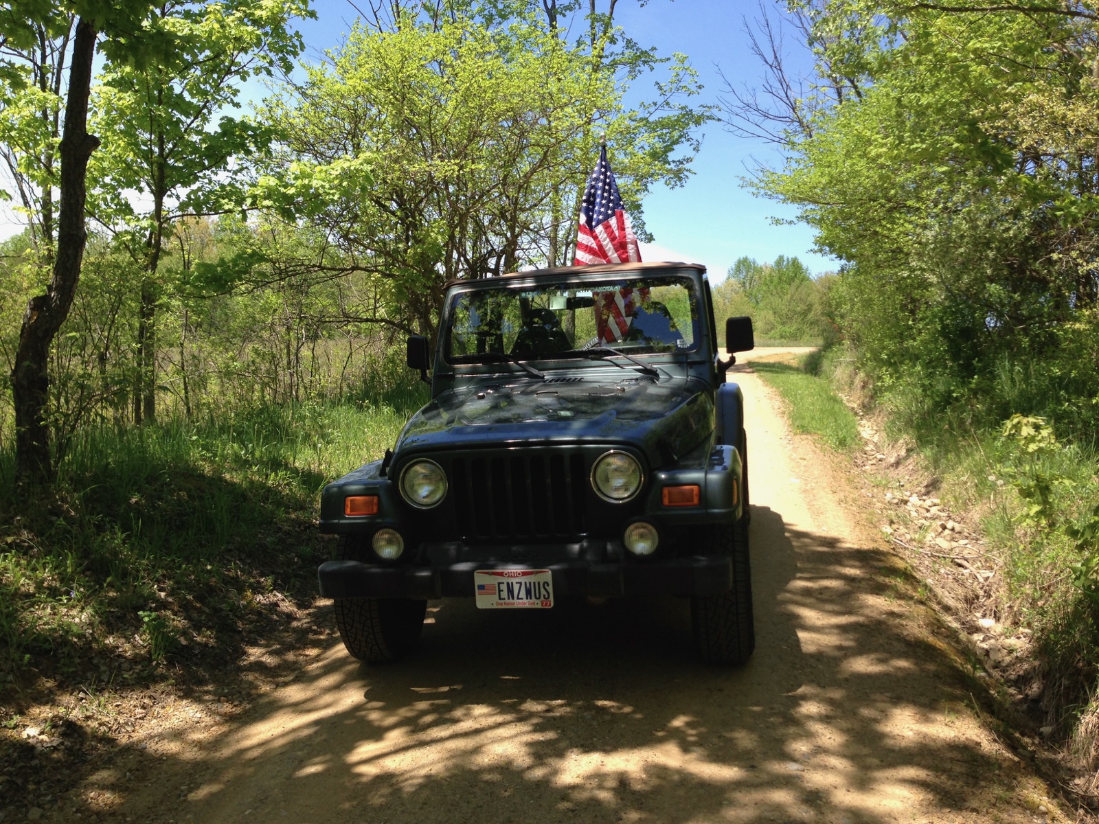 2002 Jeep Wrangler Sahara stopped on a sunny forest road